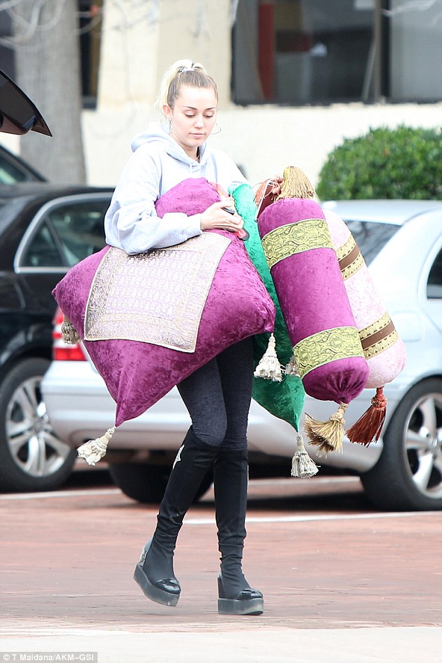 Had her hands full: Her colorful cushions were cylindrical and square with gold patterns and each featured long tassels