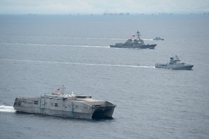 File - The forward-deployed Arliegh Burke-class guided-missile destroyer USS McCampbell (DDG 85), third ship, and the Military Sealift Command Joint High-Speed Vessel USNS Millinocket (T-EPF-3), first ship, participate in a photo exercise with Brunei Navy ships KDB Darussalam and KDB Afiat during Cooperation Afloat Readiness and Training (CARAT) 2016 in the South China Sea.