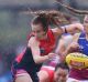 Brisbane's Tahlia Randall clashes with Sarah Lampard of the Demons at Casey Fields.