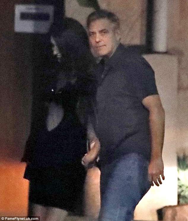 Out and about: George and Amal  - rumored to be expecting twins - were snapped at Barcelona, Spain's swanky Rooftop Smokehouse Restaurant on Thursday