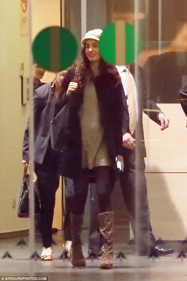 Happy time: Amid rumours she's pregnant, Amal Clooney couldn't hide her smile as she arrived at Barcelona airport with her husband George and the actor's parents on Wednesday