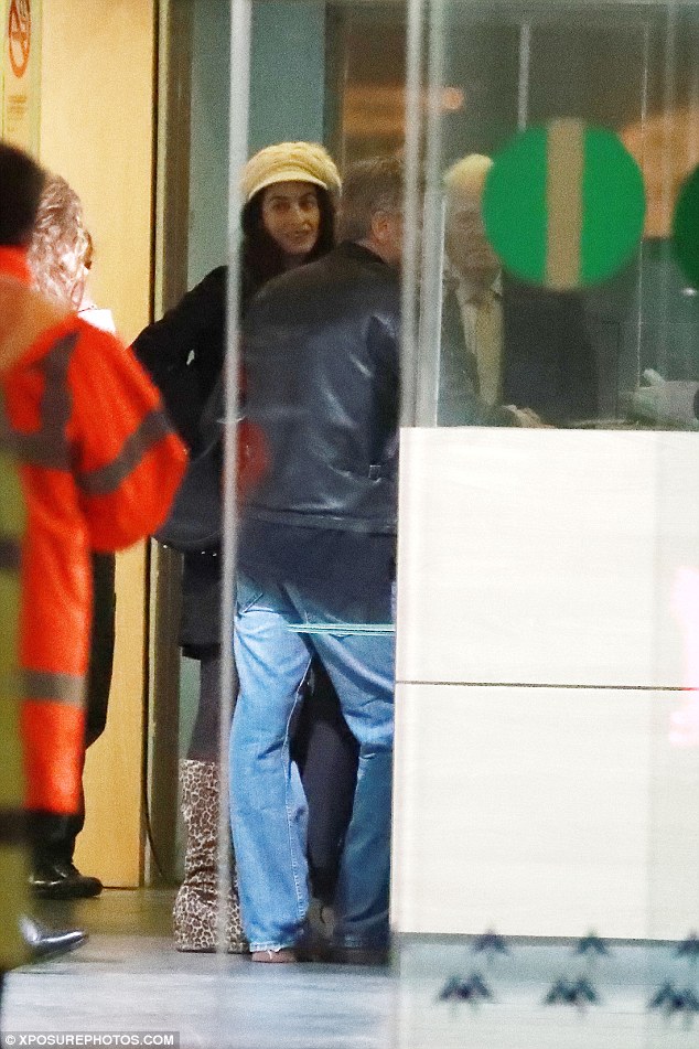 Keeping close: The couple chatted to airport staff before heading to their hotel