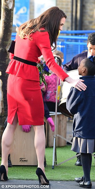 The slim-fitting skirt red suit showed off the Duchess of Cambridge's toned legs