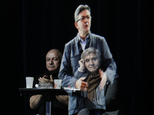 People sit at a table on stage and look towards the hologram of hard-left French presidential candidate Jean-Luc Melenchon, as he speaks to supporters who are gathered in Saint-Denis, near Paris, Sunday, Feb. 5, 2017. As Melenchon holds a rally in Lyon Sunday, a hologram of him is being projected by satellite to crowds in Paris. (AP Photo/Kamil Zihnioglu)