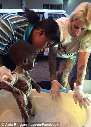 Bath time: Ms Loven is pictured helping give Hope a bath