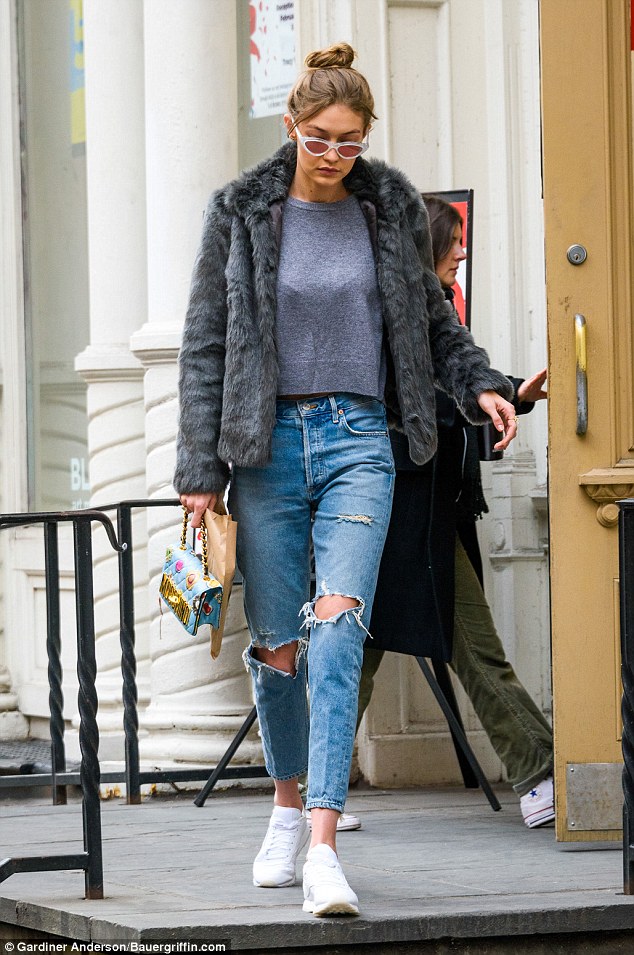 Midriff magic: The stylish girlfriend of Zayn Malik chose a grey cropped top with ripped blue denim jeans