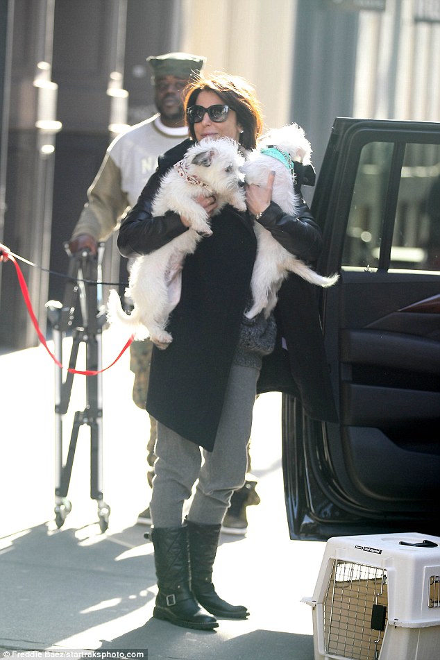 One for the road: Once Cookie was loaded into the car, Bethenny could not help but some last minute cuddles in with the puppies