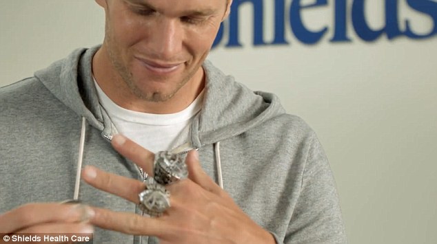 During the original ad, Brady removes each of his championship rings in succession 