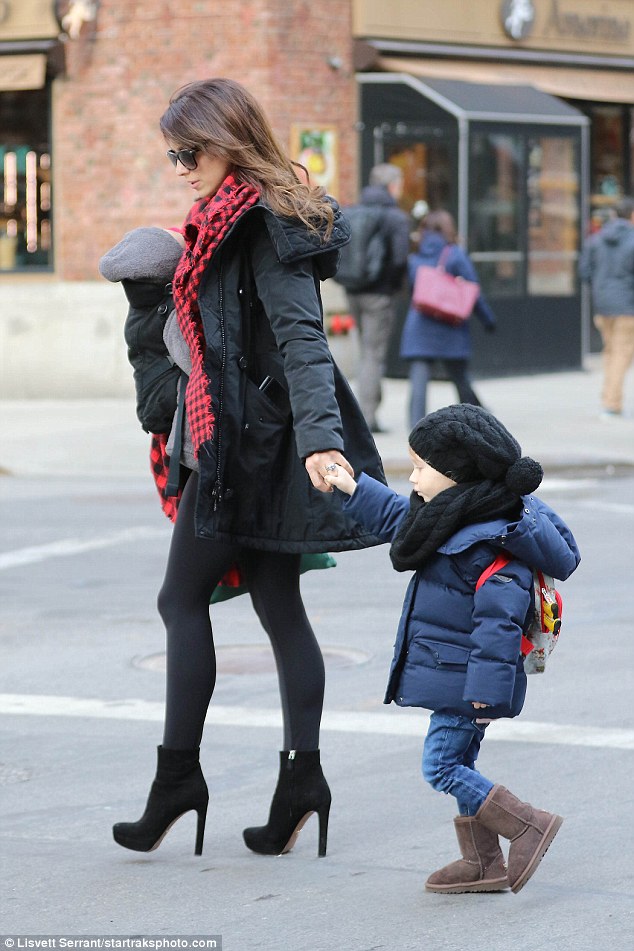 Cute: Little Carmen carried her own backpack as she wore a black hat and beige boots