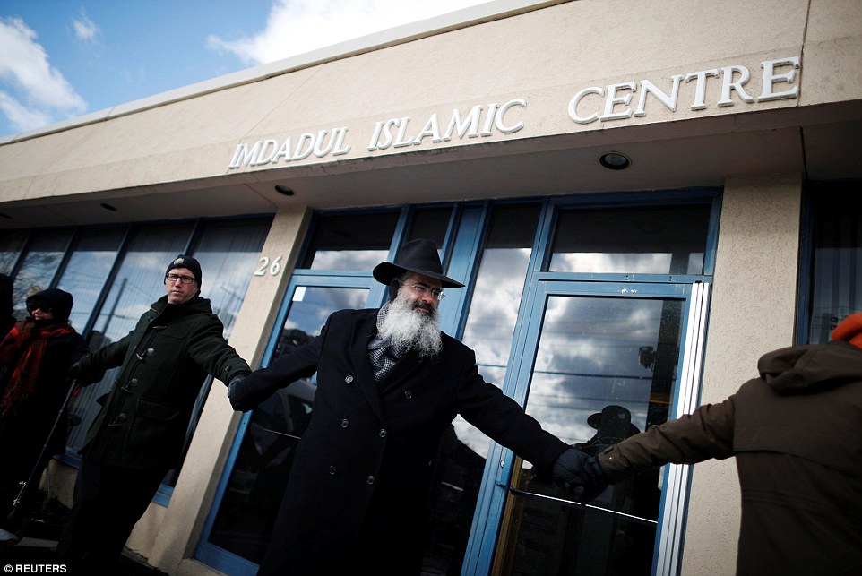 People from the Holy Blossom Temple Synagogue and the Fairlawn United Church form a 'Ring of Peace' outside The Imdadul Islamic Center during prayers to show solidarity in condemning the deadly shooting