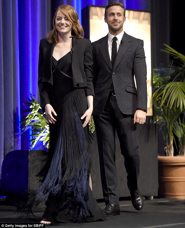 Dapper: Ryan looked dapper in his pinstriped suit behind Emma's stylish look