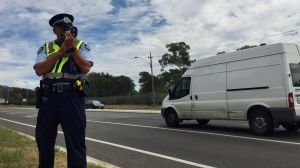 An ACT policing sergeant from Road Safety Operations checks drivers speeds on Barry Drive.