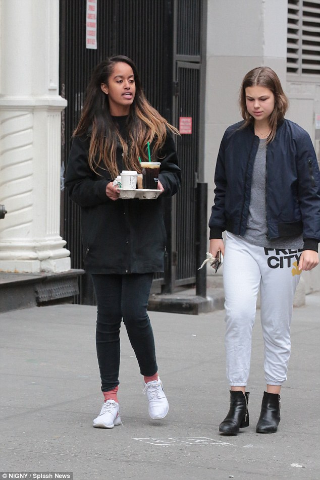 After her first week of work, Malia unwound during the weekend with a coffee date with a girl friend (above, on Sunday) 