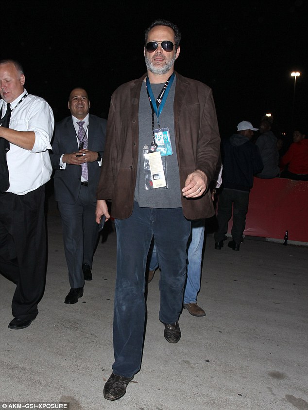 Keeping it casual: Vince Vaughn wore a brown cardigan over a grey shirt, navy blue trousers and black leather boots