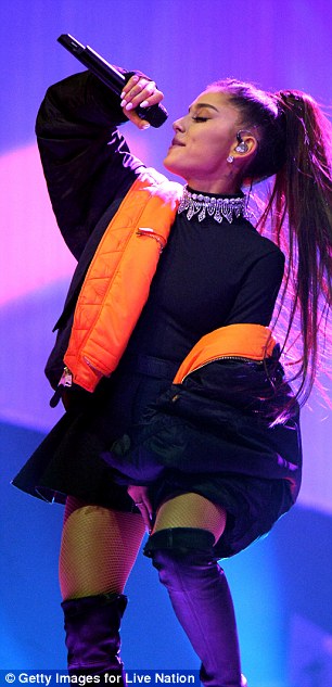 Cozy coat: The Florida-born beauty donned a black bomber jacket lined with orange over the one-piece for part of her show