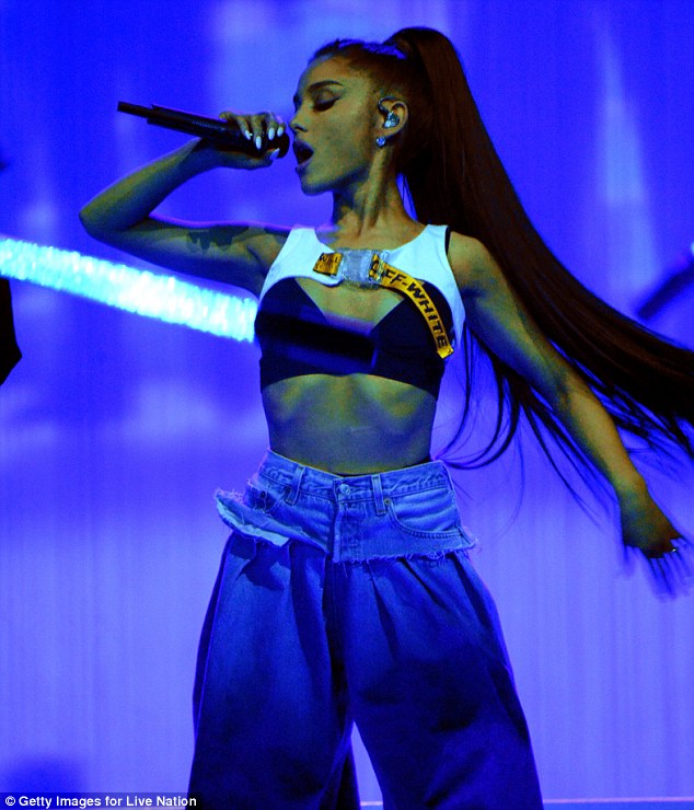 Slender star: Ariana showed off her slim waistline in the barely there cropped top