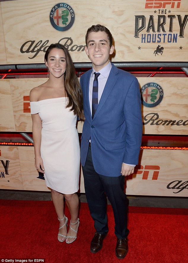 What a sport!  Aly Raisman stunned in a gorgeous white dress as she attended the bash with her brother Brett Raisman 