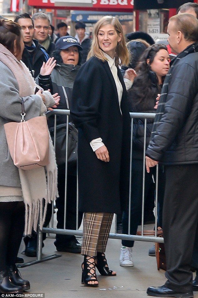 Fan love! Teaming it with a high neck crisp white blouse and a long black batwing coat, her ensemble was complete