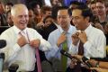 Prime Minister Malcolm Turnbull and Indonesian President Joko Widodo take off their ties during a visit to Tanah Abang ...