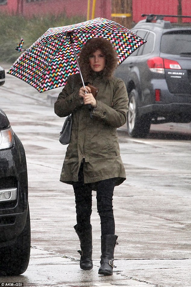 Under cover! Rachel Bilson dodges the rain as she heads out with an umbrella in Los Angeles