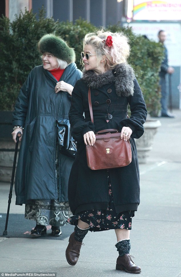 Chic: Helena stayed true to her quirky style as she bundled up in a buttoned-up black coat and added an opulent fur stole