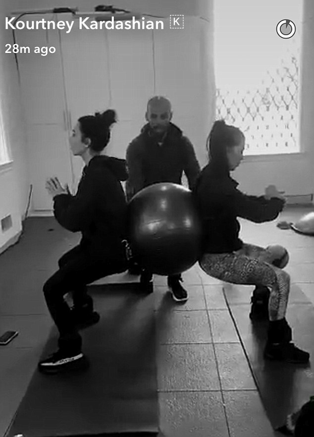 Balancing act: Kim Kardashian took to Snapchat to share a few photos of she and sister Kourtney working out