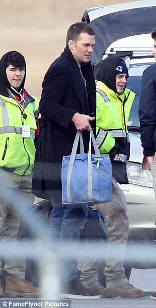 Brady is pictured carrying a bag at the airport