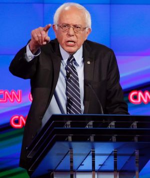 FILE - In this Tuesday, Oct. 13, 2015, file photo, Sen. Bernie Sanders, of Vermont, left, speaks as Hillary Clinton ...