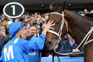 Another level: Hugh Bowman gives Winx a pat after her second Cox Plate victory.