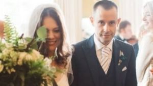 Angelia Cuming and her husband Paul walk down the aisle on their wedding day. 