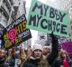 Demonstrators hold signs while marching towards Trump Tower during the Women's March in New York, U.S., on Saturday, ...