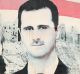 Pro-government supporters hold up the national Syrian flag and pictures of Syrian President Bashar al-Assad in Aleppo ...