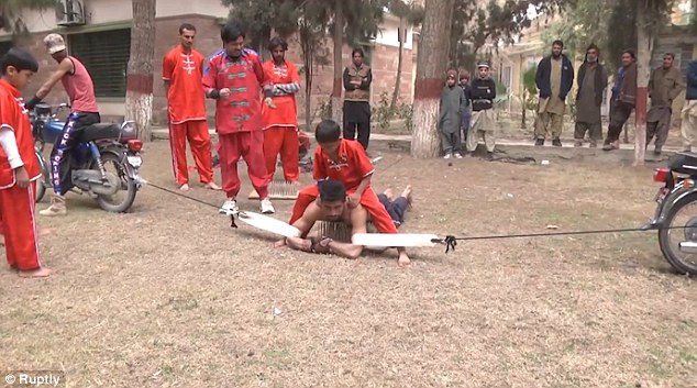 Another section of the film shows a man being stretched by two motorbikes attached to both feet with rope