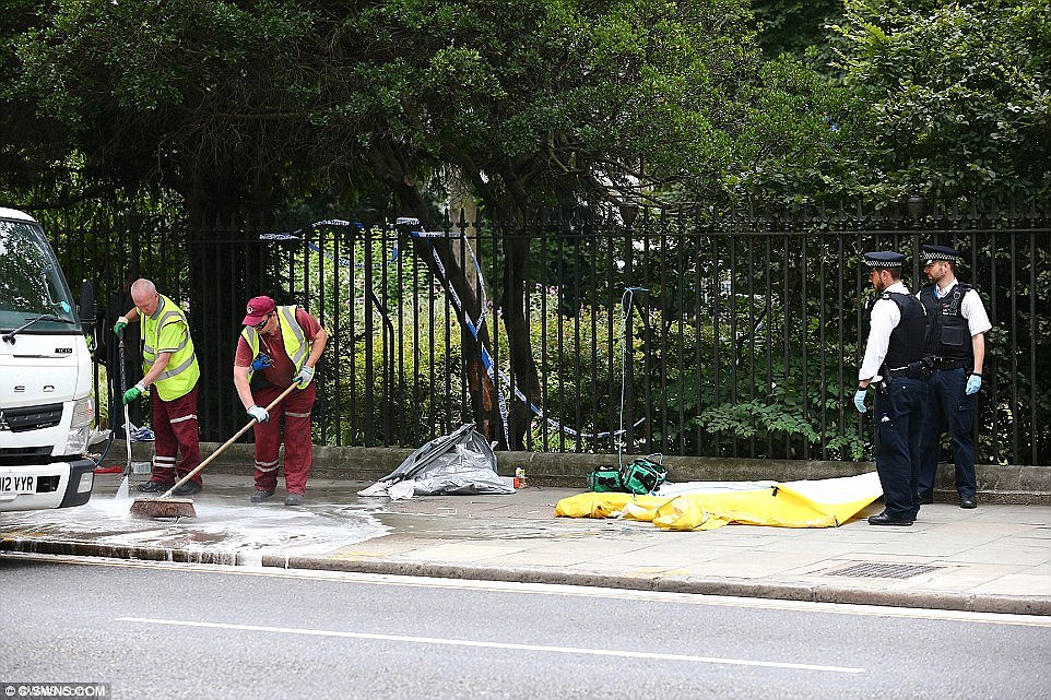 Council workers wash the pavement on Russell Square the day after Bulhan's deadly attack left scenes of chaos