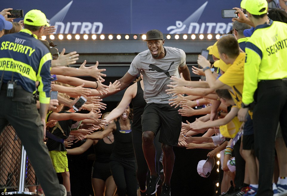 High five: Jamaican sprinter Usain Bolt runs onto the field at the start of the Nitro Athletics series