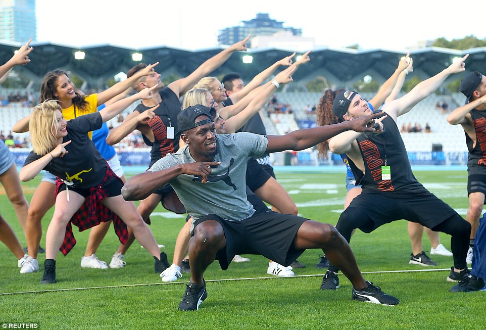 Olympic champion Usain Bolt dances with entertainers before the start of the Nitro Athletics series