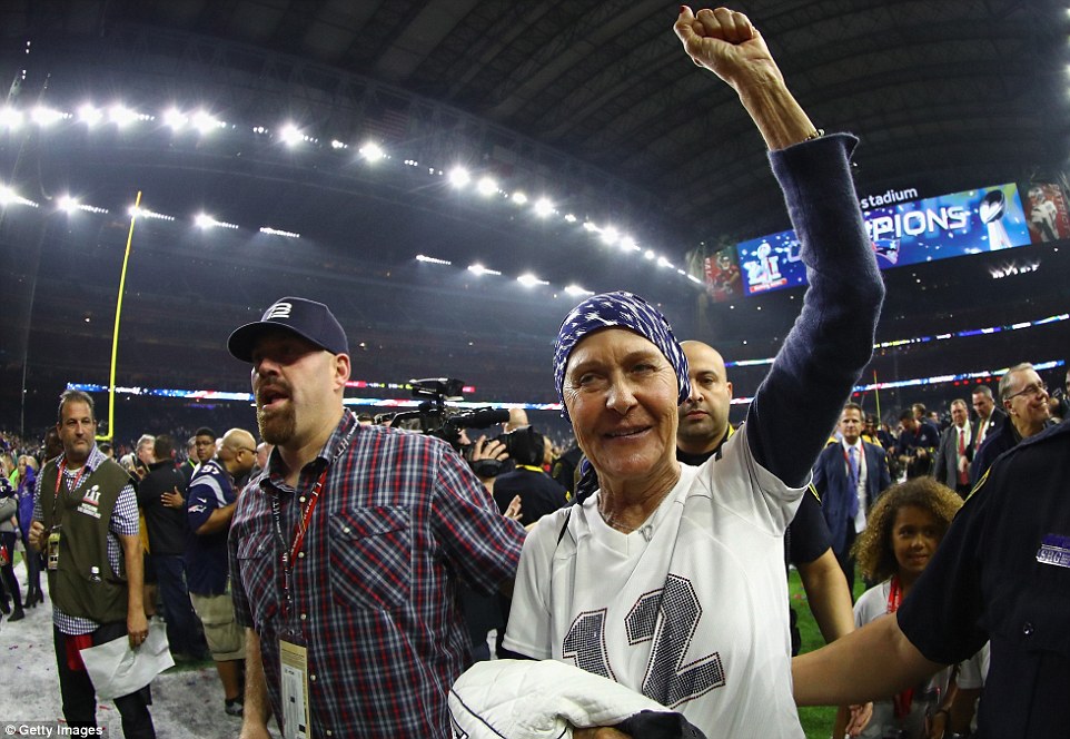 Brady's mother, Galynn, celebrated on the field with the football star's brother-in-law, former Red Sox player Kevin Youkilis (left)