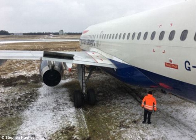 A passenger on board a British Airways jet that slid off a runway in Denmark tweeted a picture of the stricken jet (above) with the caption 'the guy in the jacket is like "how are we going to get this plane out this ditch?!"'