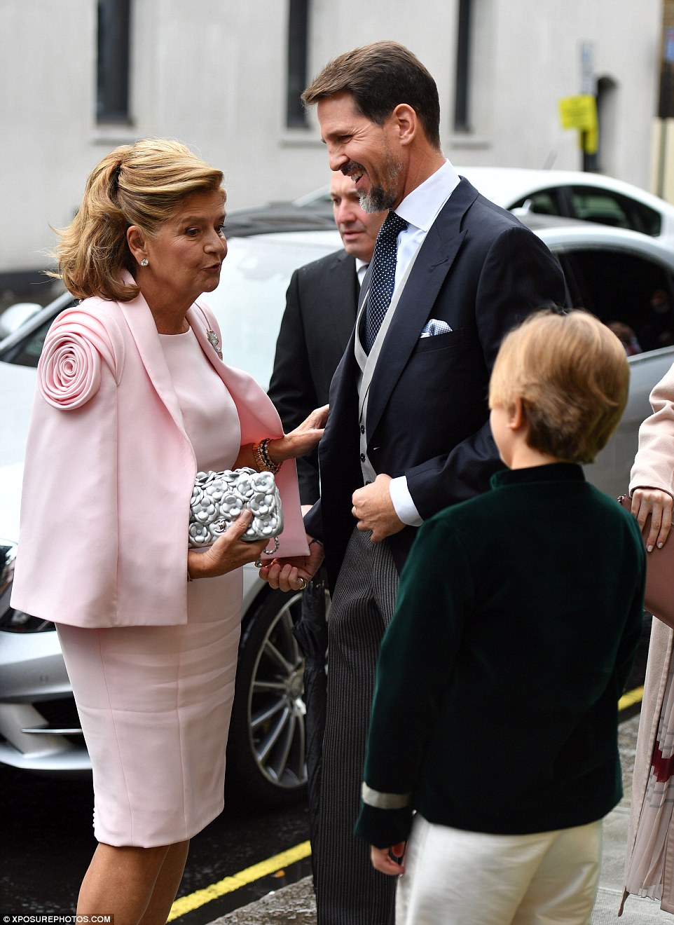 Crown Prince Pavlos of Greece wore a white shirt and blue and white tie as he spoke to other guests who attended the wedding 