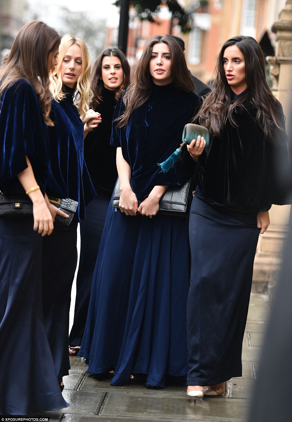 Marianna's troupe of bridesmaids wore matching indigo dresses complete with a midnight blue velvet cape to accompany her down the aisle