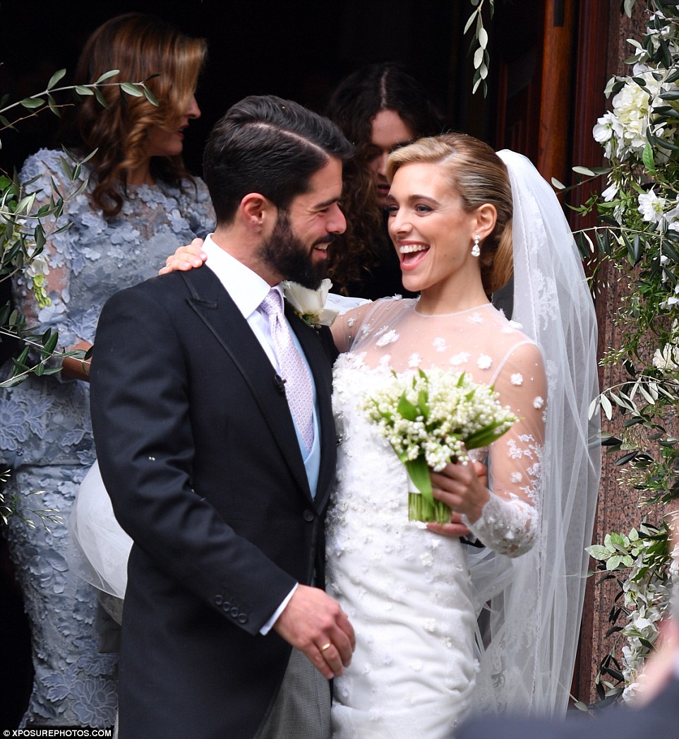 The delighted newlyweds were glowing with happiness as they emerged from the church after the ceremony 