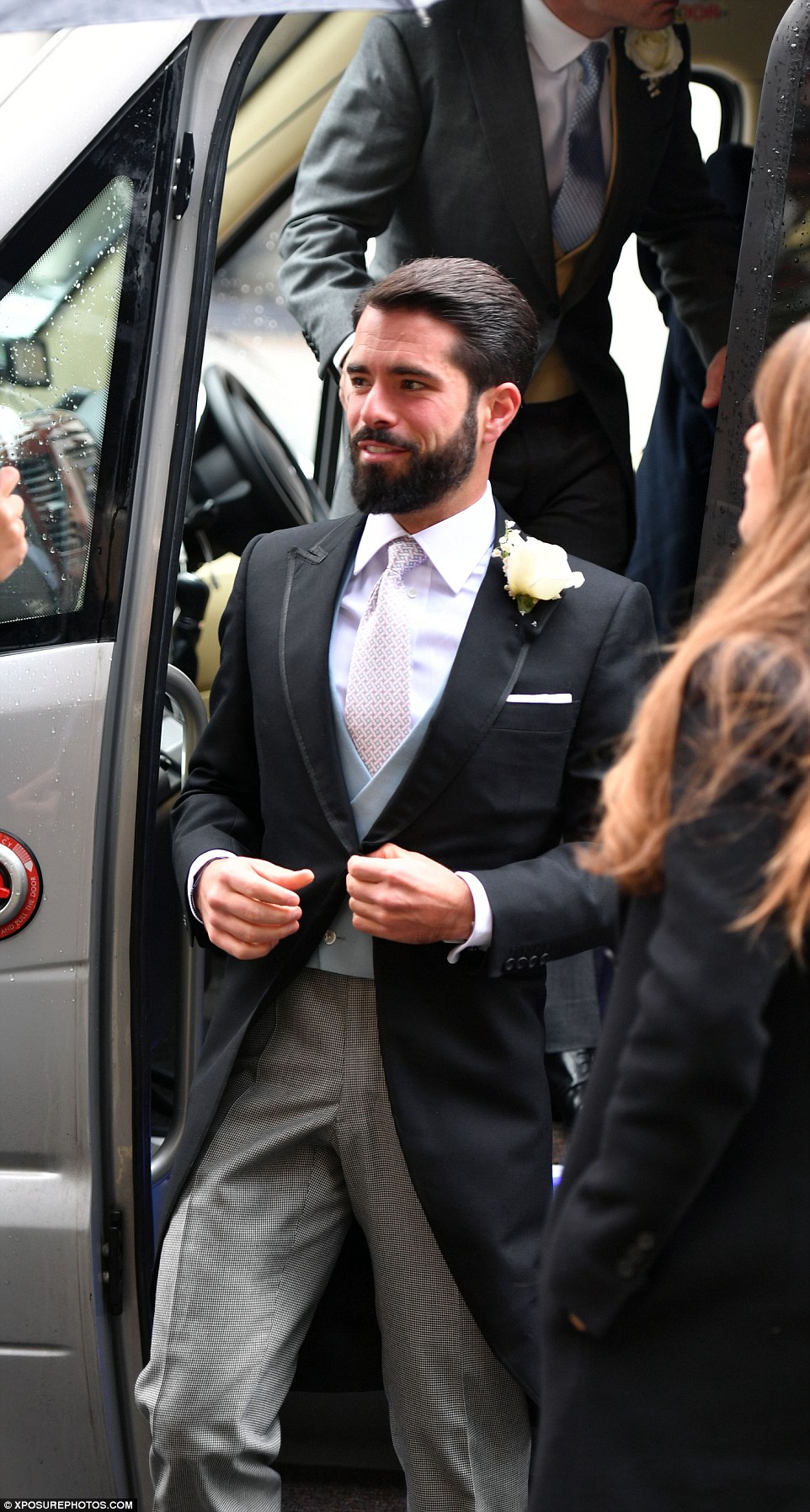 The handsome groom arrives to celebrate his big day on a rainy afternoon in London 