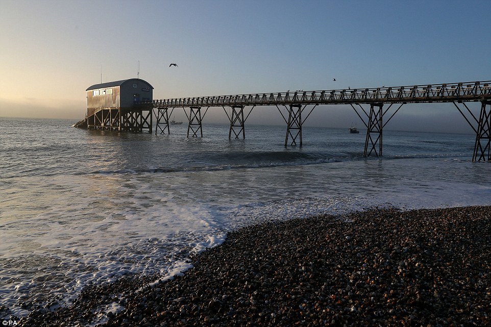 The rising sun lights up Selsey Lifeboat station in West Sussex this morning as Britain prepares for another cold snap