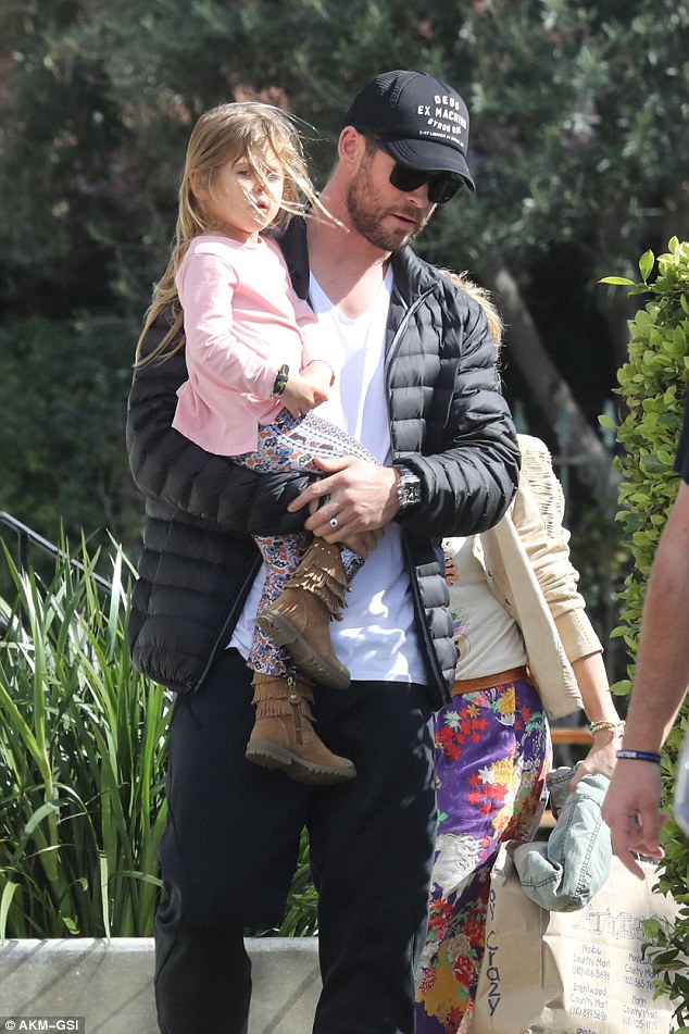 Daddy's little girl: Chris affectionately carried his daughter India Rose