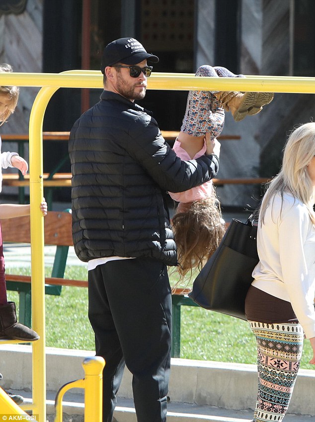 Child's play! Hemsworth carefully supervised India as she played about in the jungle gym