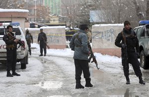 Security personnel stand guard at the site of a suicide attack on the Supreme Court in Kabul, Afghanistan, Tuesday, Feb. 7, 2017.