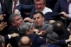 Turkish politicians scuffle in parliament during deliberations over a controversial package of constitutional amendments.