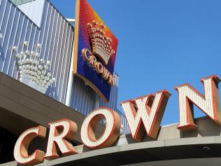 (FILES) A file photo taken on February 26, 2010 shows Crown signs displayed on the Crown Casino building in Melbourne. Australian mogul James Packer's Crown Resorts on December 15, 2016 slashed its stake in a Macau joint-venture and shelved plans for a Las Vegas casino in a scaling back of operations to cut debt. The casino operator, reeling from 18 staff being detained in China in October, also said it would scrap a proposal to spin-off global assets. / AFP PHOTO / WILLIAM WEST