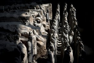 Sunlights cast shadow on the unearthed terracotta warriors displaying at the excavation site inside the No.1 pit of the Museum of Qin Terracotta Warriors and Horses in Xi'an, in central China's Shaanxi province Tuesday, July 30, 2013. Thousands of terracotta soldiers that were buried in the tomb of the Emperor Qin Shihuangdi, who ruled China between 221-210 B.C., are displayed in Xi'an. (AP Photo/Andy Wong)