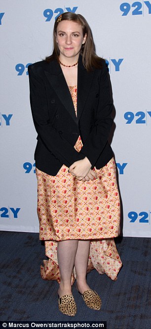 Simple and classy: She wore a knee length orange printed silk dress, which she teamed with a black blazer and a beaded choker necklace